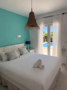 a bedroom with a large white bed with two towels on it at Villa Sal y Mar - Jávea ! Freshly Renovated ! in Jávea +32 photos