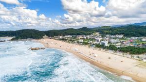 an aerial view of a beach with people on it at Yangyang Hajodae Campingcar in Yangyang