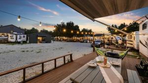 an outdoor deck with a table and chairs and an rv at Yangyang Hajodae Campingcar in Yangyang +17 photos