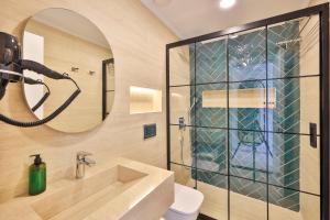 a bathroom with a sink and a mirror at Sardunya Otel ARKA BİNA in Kaş