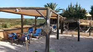 a patio with chairs and a table and aokedokedokedoked at Yellowstone in Kefalos