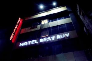 a hotel best run sign on a building at night at Hotel best buy in Kolkata