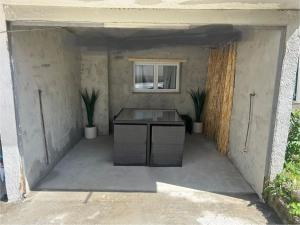 a garage with a table and two plants in it at Appartement cosy et confortable Chez Lyne in Laragne