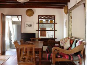 a living room with a table and a couch at Rumah Jah Langkawi in Pantai Cenang