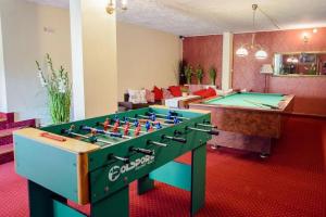 a living room with a pool table and ping pong ball at Willa za Wodą in Zakopane
