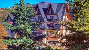 a large building with trees in front of it at Willa za Wodą in Zakopane