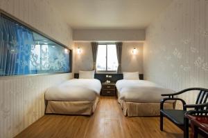 เตียงในห้องที่ Lishin Hotel