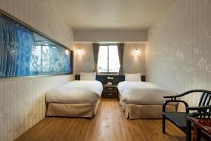 Postel nebo postele na pokoji v ubytování Lishin Hotel