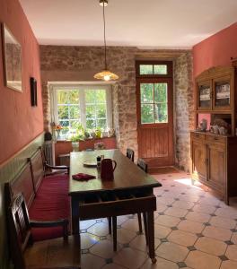 a kitchen with a table and chairs in a room at Manoir La Buissonnière in Plescop