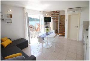 a living room with a couch and a table at Apartment Karmela in Primošten