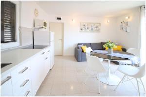a kitchen and living room with a table and chairs at Apartment Karmela in Primošten