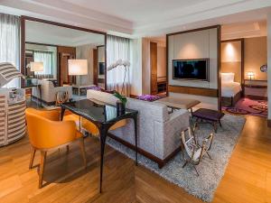 a living room with a couch and a table at Sofitel Singapore Sentosa in Singapore