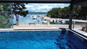 a swimming pool with a view of a marina at Boutique Resort Villa VISTA in Malinska