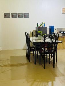 a dining room table and chairs in a room at Gabs Haven Transient House in El Nido +3 photos