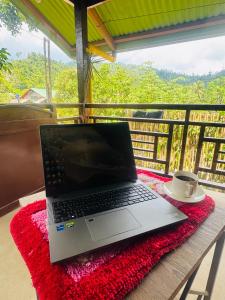 a laptop computer sitting on a table with a cup of coffee at Gabs Haven Transient House in El Nido