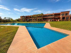 a large swimming pool in front of a building at Elegant, quiet villa in Marrakesh