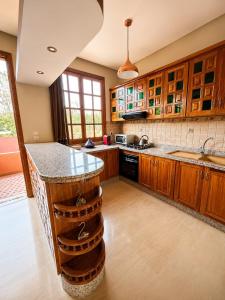a kitchen with wooden cabinets and a counter top at Elegant, quiet villa in Marrakesh