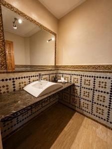 a bathroom with a sink and a large mirror at Elegant, quiet villa in Marrakesh +40 photos