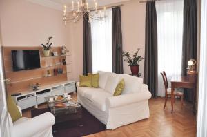 a living room with a white couch and a tv at Business Home Vienna in Vienna