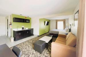 a hotel room with a bed and a sink at Quality Inn & Suites Clemmons I-40 in Clemmons