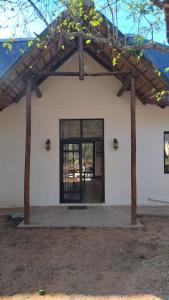 a building with a large glass door in front at Marloth Park, Kruger safari house - solar in Marloth Park