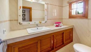 a bathroom with a sink and a mirror at La Vijanera in Sant Jordi +18 photos