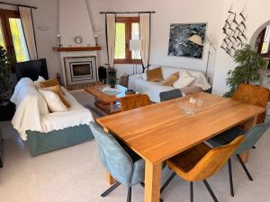 a living room with a wooden table and a couch at Villa Sal y Mar - Jávea ! Freshly Renovated ! in Jávea