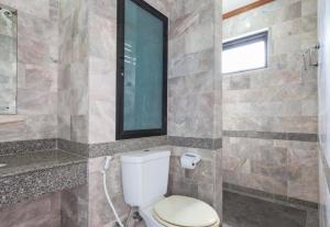 a bathroom with a toilet and a mirror at Onnicha Hotel Phuket in Phuket +18 photos