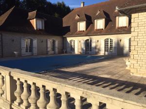 a large house with a fence in front of it at Le Belvédère in Thiviers