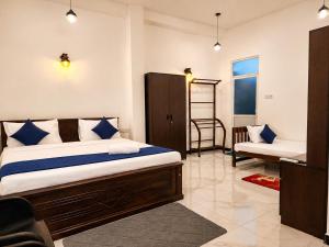 a bedroom with a bed and a chair in it at Silva Nest Recidencies in Galle