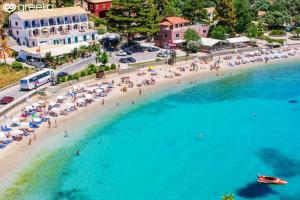 an aerial view of a beach with people and umbrellas at Rubick solari studio in Mantoúkion +3 photos