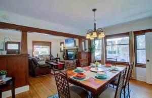 a dining room and living room with a table and chairs at "Univeristy" Charming Craftsman - 3 bd, 2ba in Riverside in Riverside