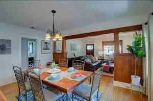 a dining room and living room with a table and chairs at "Univeristy" Charming Craftsman - 3 bd, 2ba in Riverside in Riverside +2 photos