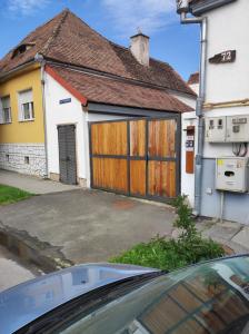 a car parked in front of a garage at The little White House in Sibiu