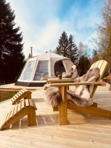 a picnic table with a tent in the background at Torshaug glamping in Trondheim