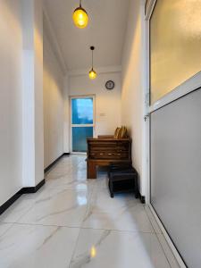 a hallway with a piano in a room at Silva Nest Recidencies in Galle