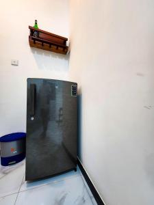 a black refrigerator in a corner of a room at Silva Nest Recidencies in Galle