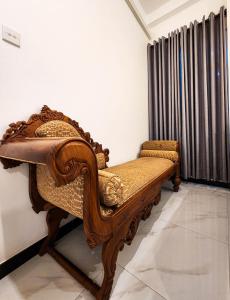 a wooden bench in a room with a window at Silva Nest Recidencies in Galle +24 photos