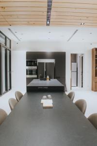 a dining room with a large black table and chairs at Chungi Hotel 純吉民宿 咖啡 in Xincheng