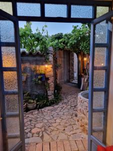 an entrance to a building with a stone walkway at Casa Olive in San Vito