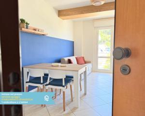 a dining room with a table and chairs at Sogni blu in Numana