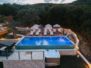 an outdoor swimming pool with chairs and a swimming poolvisor at Azure Olive Collection in Ulcinj