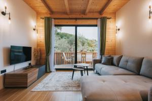 a living room with a couch and a television at Azure Olive Collection in Ulcinj
