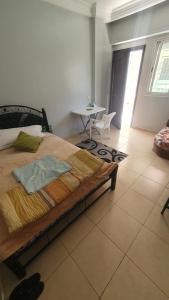 a bedroom with a bed and a table in a room at Sweet Room in Casa in Casablanca