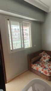 a bedroom with a bed and a window at Sweet Room in Casa in Casablanca +3 photos