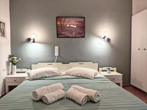 a bedroom with a bed with two towels on it at Apartments Papadioti in Pefki +40 photos