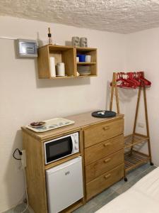 a kitchen with a counter with a microwave and a stove at Pinelopi Room in Olbia