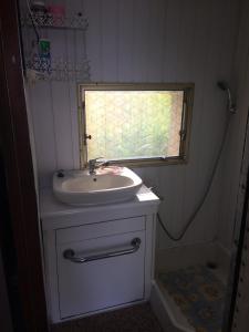 a small bathroom with a sink and a window at Duży kemping in Ustronie Morskie +7 photos