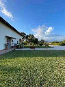 a park with a bench in front of a building at Casale Country Chic- Sabaudia in Borgo Isonzo