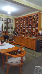 a room with a table and shelves of wine bottles at Honey House Martinovic in Cetinje +51 photos